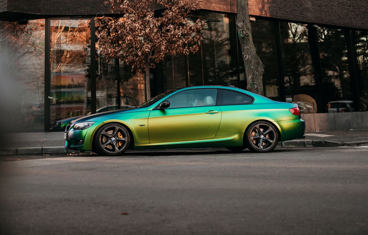 Photo of a metallic car on an empty street corner